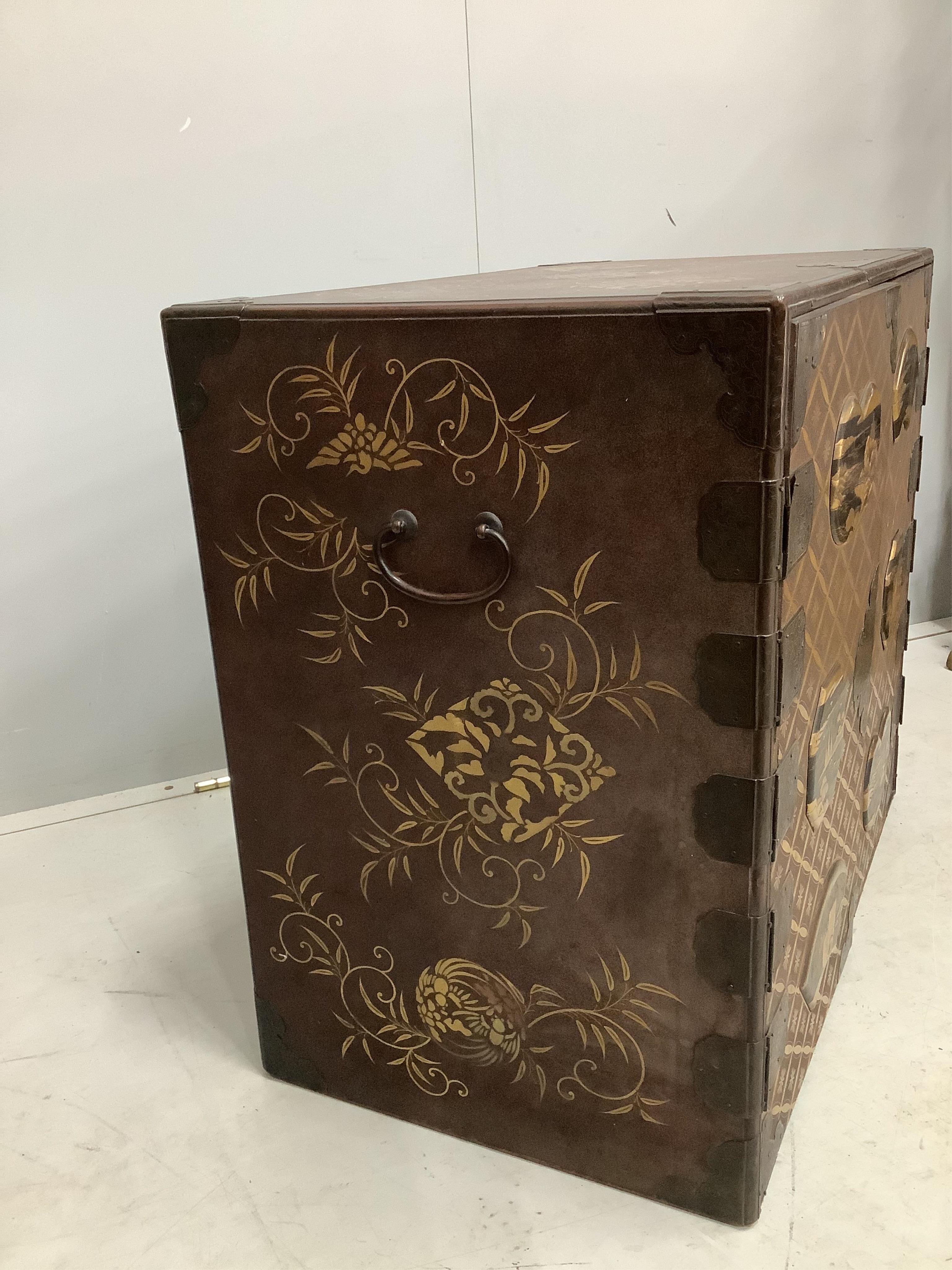 A 19th century Japanese gilt decorated lacquer table cabinet with two doors enclosing three drawers, width 61cm, depth 36cm, height 54cm. Condition - fair to good